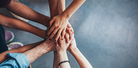Stack of hands showing unity