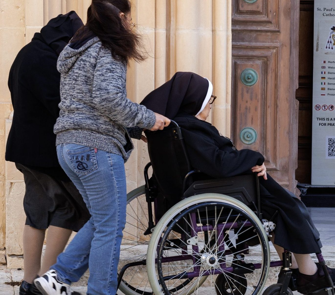 A_nun_being_helped_into_the_church